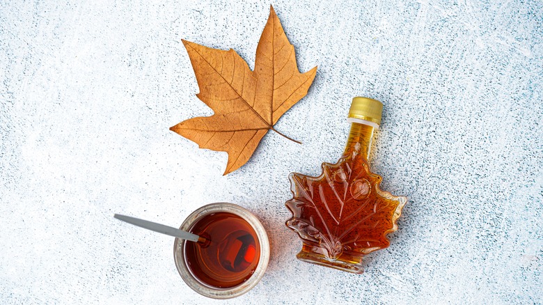 Maple leaf with bottle and bowl of syrup