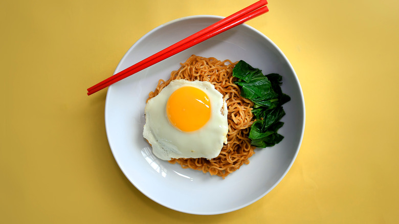 Noodles with greens and egg on top