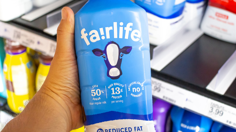 Hand holding bottle of Fairlife ultra-filtered milk