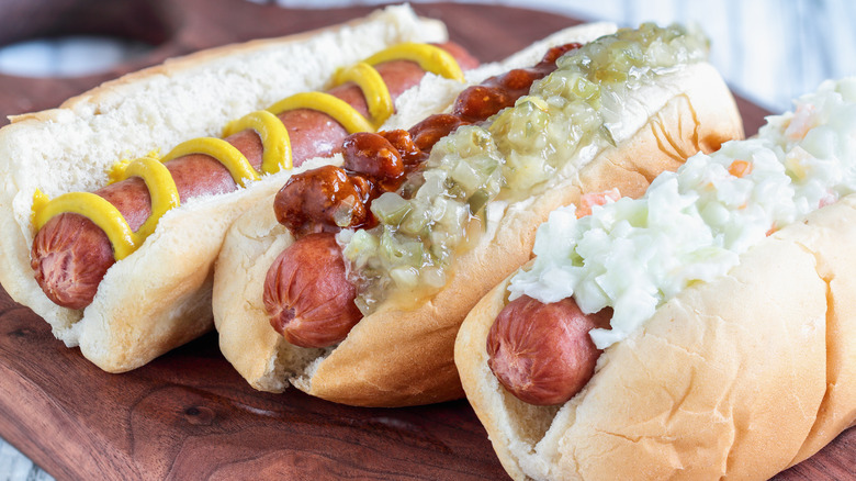 Hot dogs with coleslaw, relish and chili, and mustard