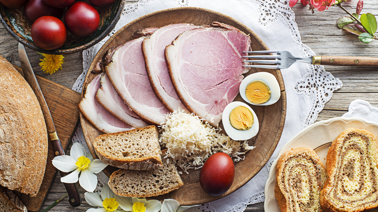 ham steak with boiled eggs, cheese, bread, and fruit