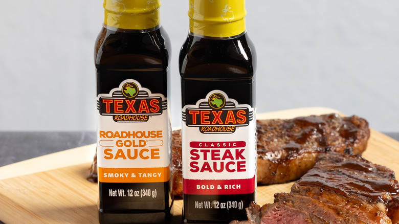 Texas Roadhouse's Classic Steak Sauce and Gold Sauce next to sliced steak