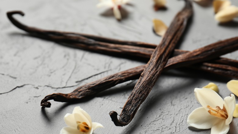 Dried vanilla pods and orchids