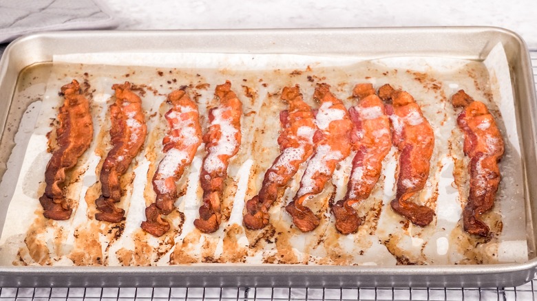 Bacon strips on parchment lined sheet pan