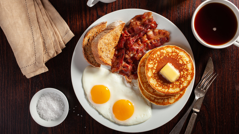 Breakfast of bacon, pancakes, and eggs