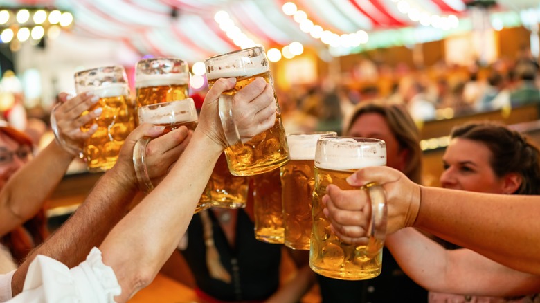 Group of people clinking beer mugs