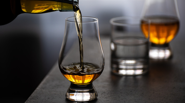 whiskey being poured into a glass