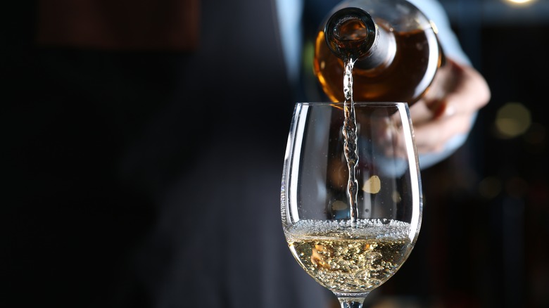 Pouring glass of white wine