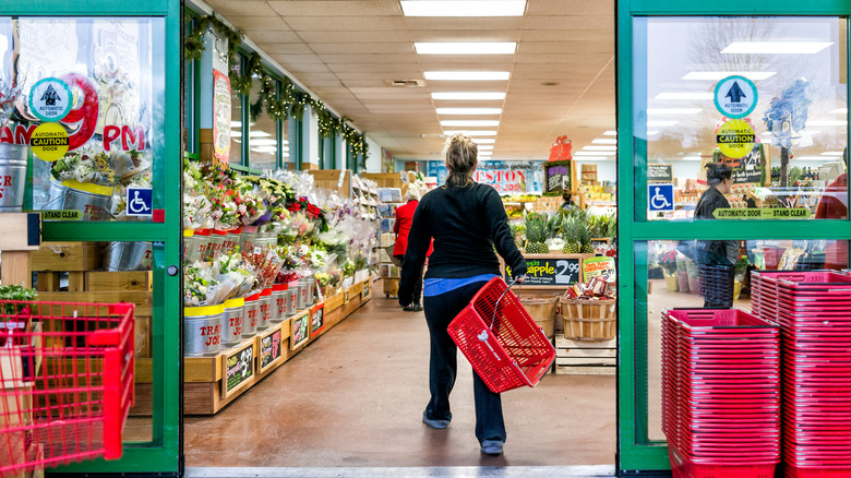 person walking in to a trader joe's