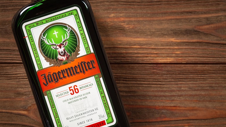 A bottle of Jägermeister laying flat on a wooden table