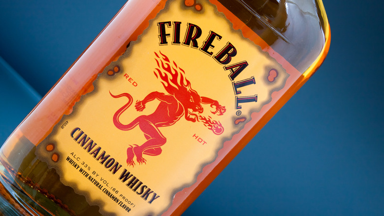 A close-up shot of a Fireball cinnamon whisky bottle