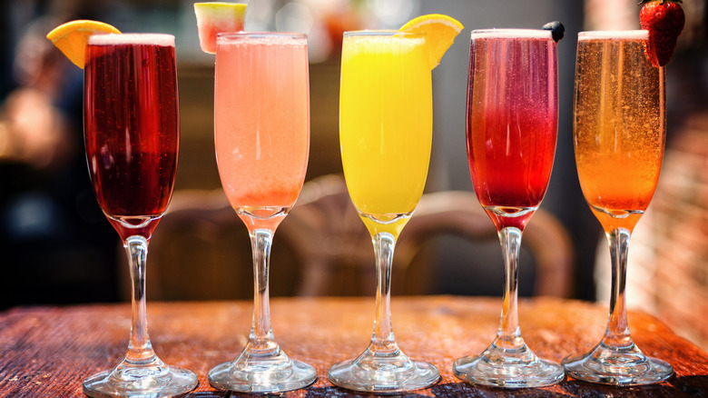 Selection of champagne cocktails with different fruits