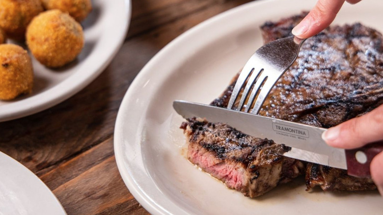 Cutting steak with knife