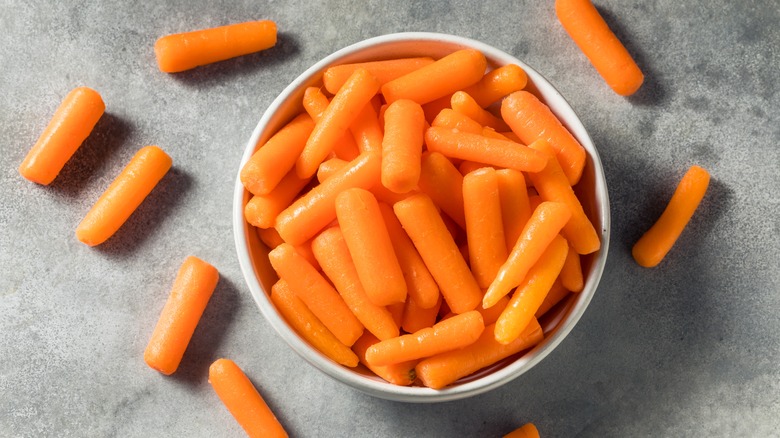 White bowl of baby carrots