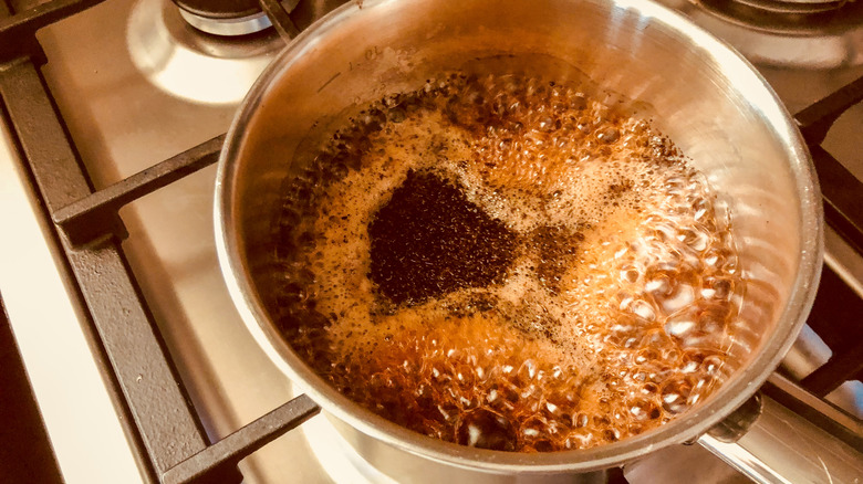 making pot of chai on stove