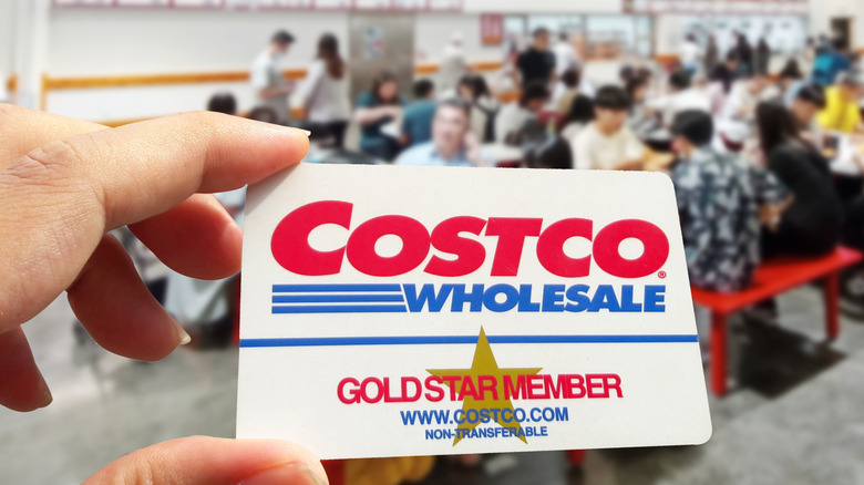 Person holding Costco card at food court