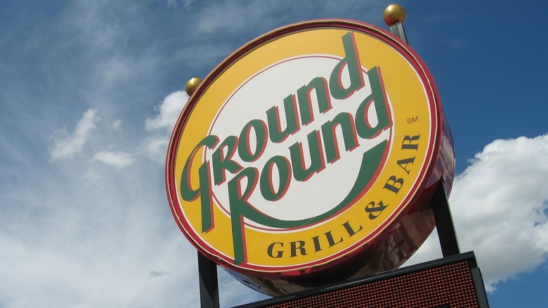 Ground Round circular sign in North Dakota soars against a cloudy blue sky