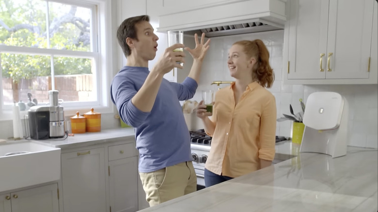 Actors in a commercial having their minds blown by Juicero juice while standing in the kitchen