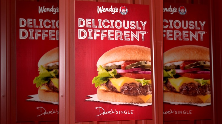 A Wendy's advertisement showing a Dave's single burger with the phrase, "Deliciously different"