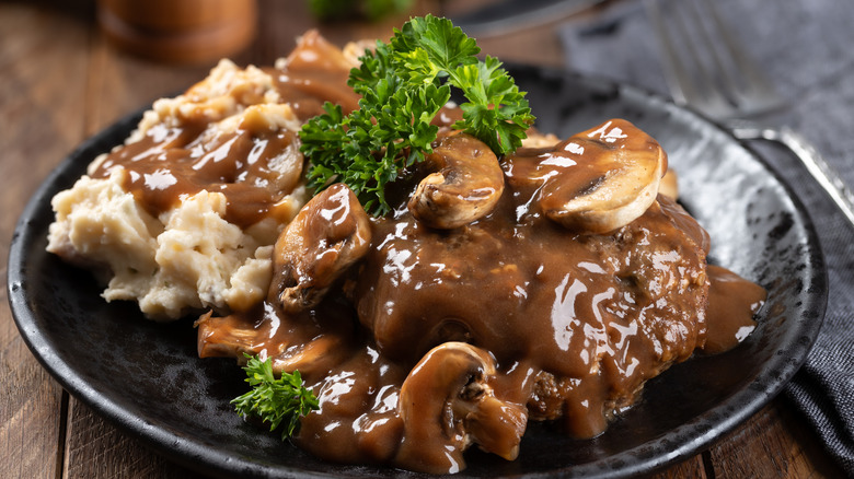 plate of Salisbury steak with gravy and broccoli