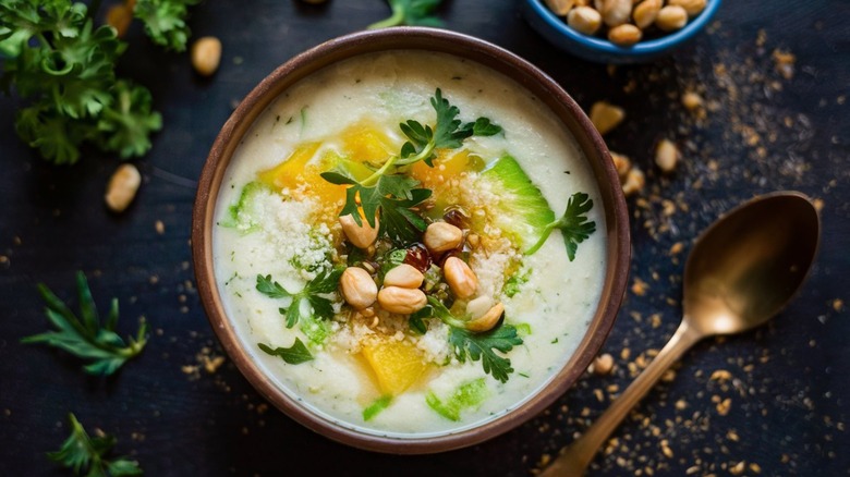 Bowl of white gazpacho soup with pine nuts