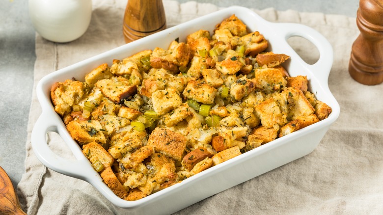 White ceramic casserole dish full of bread-based dressing