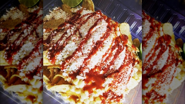 Mexican loaded nachos with corn, cotija cheese, chamoy