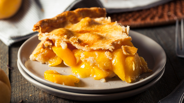 slice of peach pie on ceramic plate