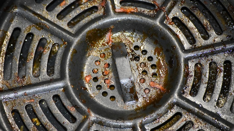 Close up of dirty air fryer grate