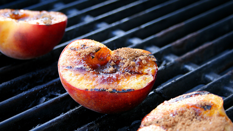 grilled peach halves on grill grates