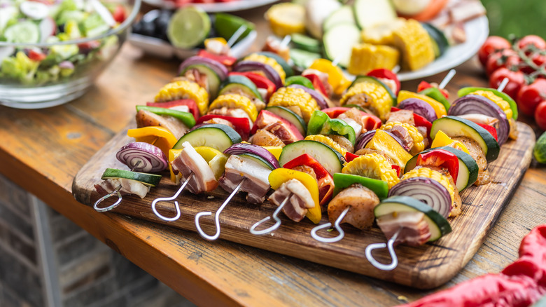 Kebabs on wooden cutting board