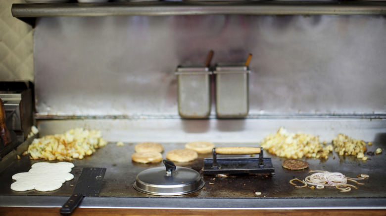 A griddle with a variety of breakfast foods