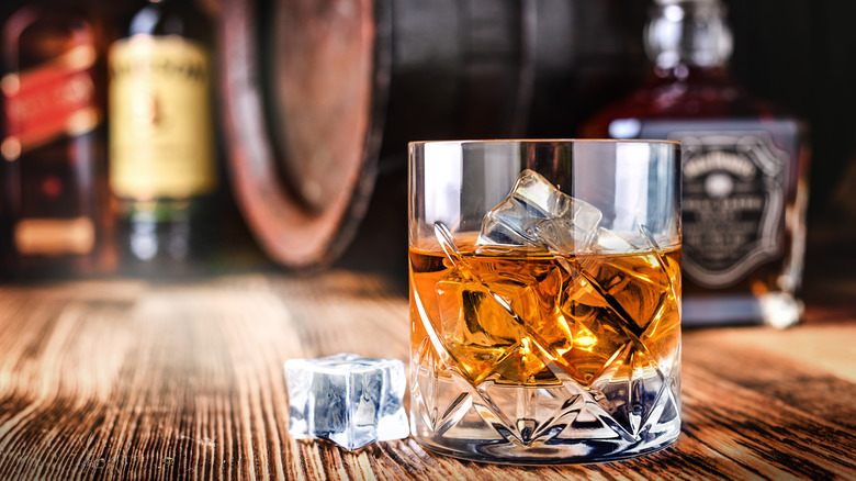 Whiskey with ice cubes on a table