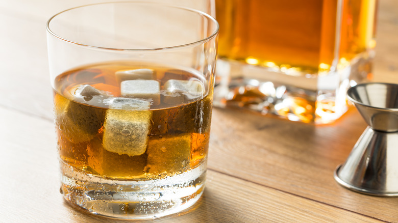 Glass of whiskey containing several whiskey stones