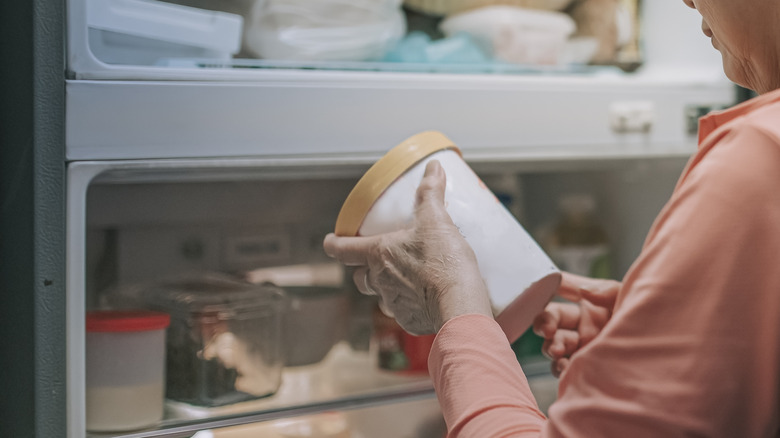 checking ice cream carton from freezer