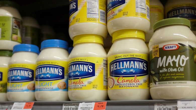 Jars of mayonnaise wait on a grocery shelf