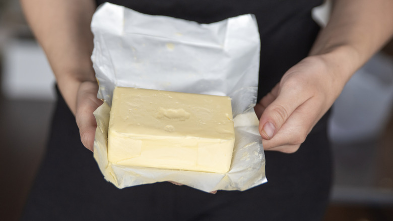 Person holding a block of butter