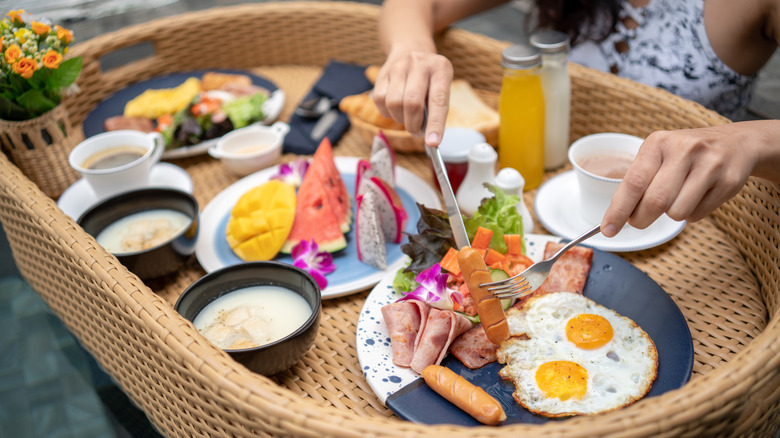 Eating sausage on floating breakfast basket