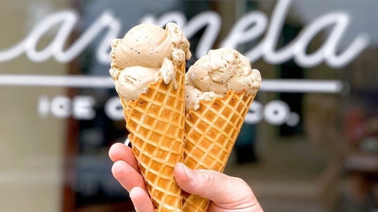 Hand holding two ice cream cones