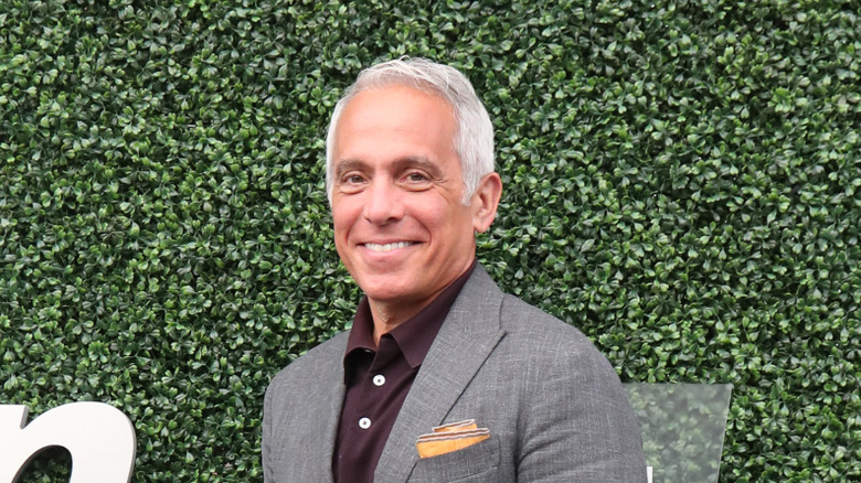 Chef Geoffrey Zakarian smiling against green background