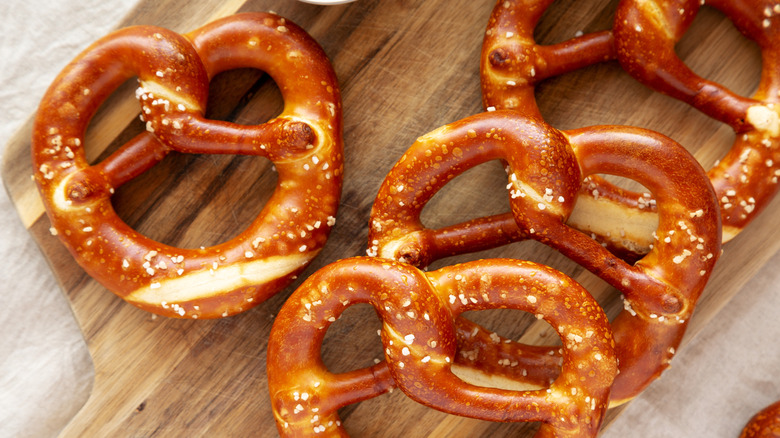 Homemade soft Bavarian pretzels on a wooden cutting board