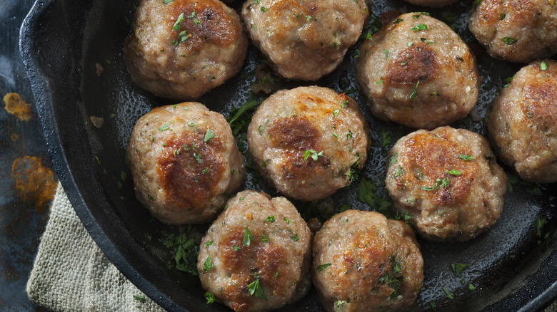 Italian-style turkey meatballs in a cast iron pan