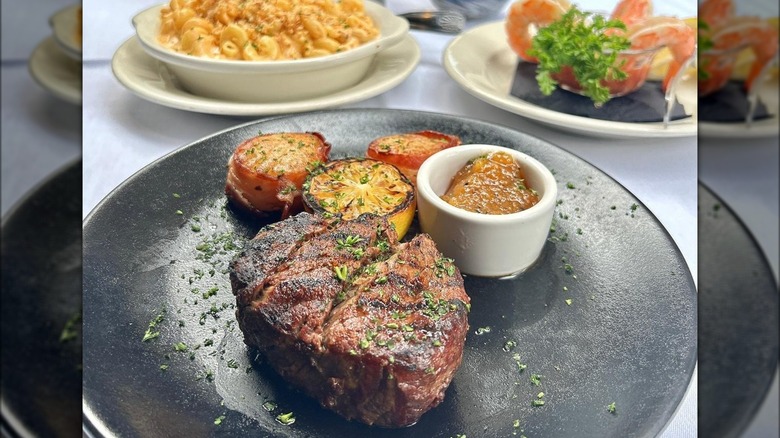 Steak and tomatoes black plate