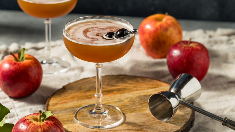 Apple cider and bourbon cocktail with apples