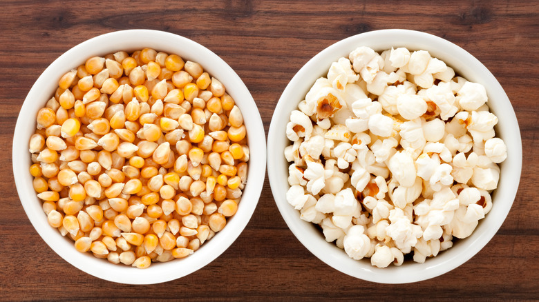 Bowls of unpopped and popped corn kernels