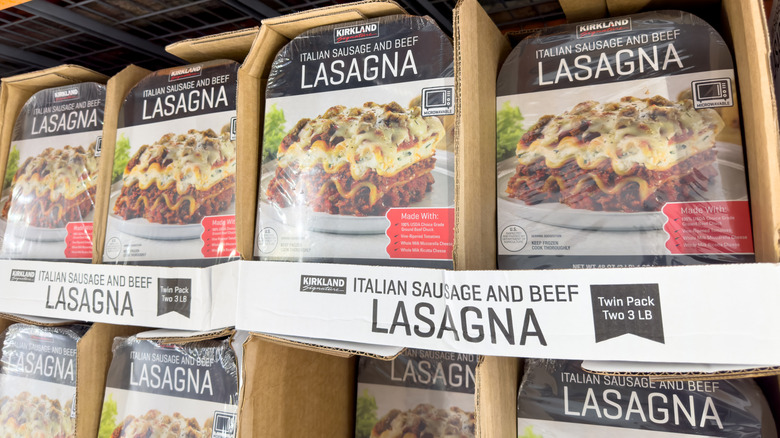 A lineup of Costco's Kirkland Signature lasagna on shelves at a Costco store