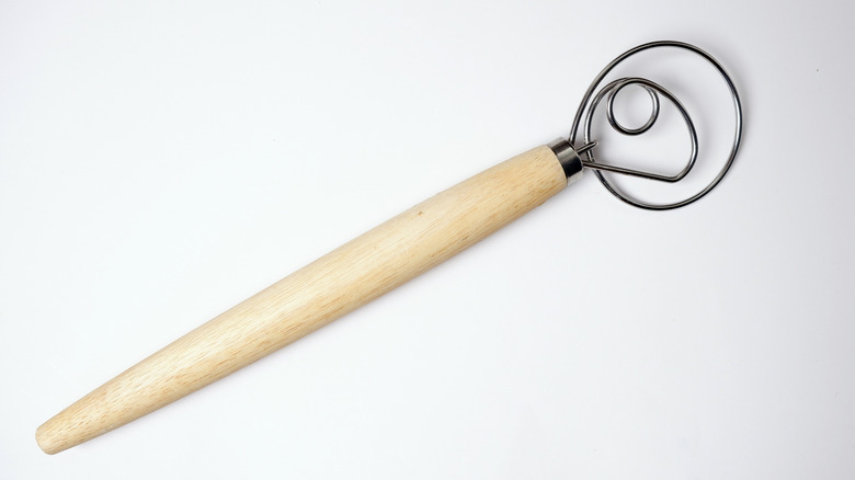 A Danish dough whisk against a white background