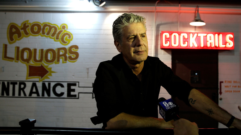 Anthony Bourdain being interviewed in front of bar