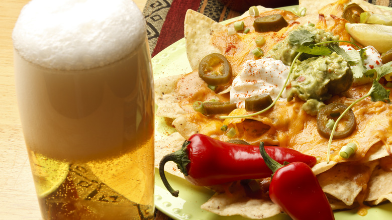 Closeup of beer and plate of nachos