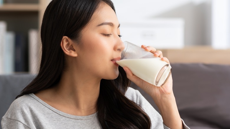 Person drinking milk from glass
